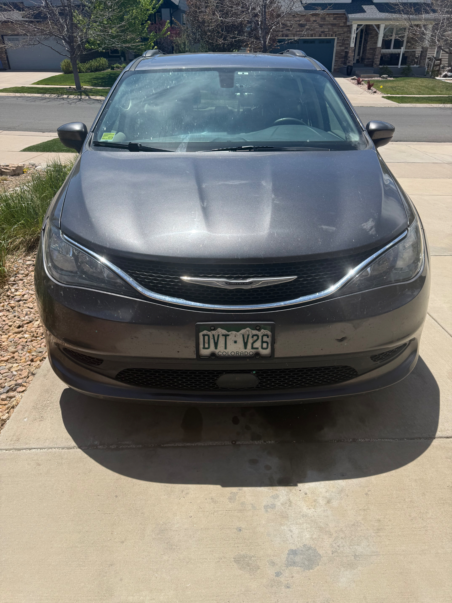 Bill's gray minivan parked on a quiet Denver street